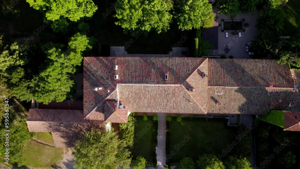 Drone Top Shot of a Southern French Castle's Rooftop with Twin Towers, Surrounded by Trees and Gardens Drone Top Shot of a Southern French Castle's Rooftop with Twin Towers, Surrounded by Trees and Gardens