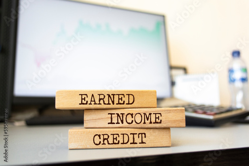 Wooden blocks with words 'EARNED INCOME CREDIT'. Business concept