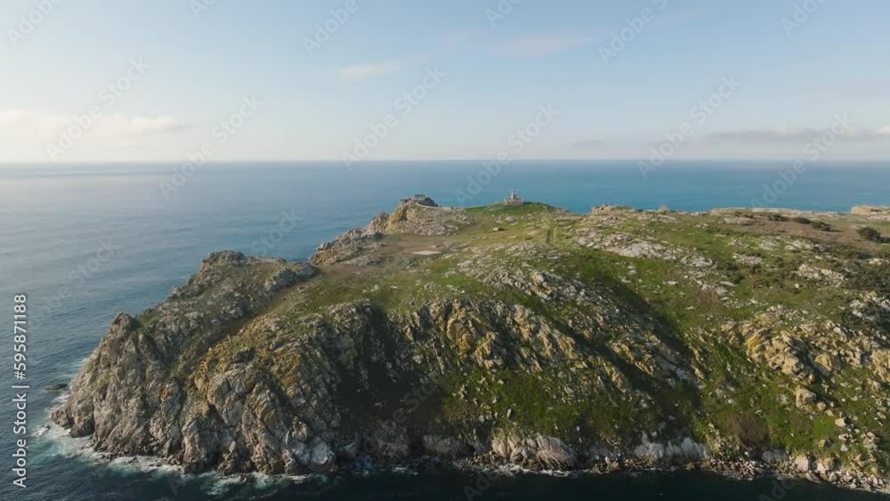 Ocean Waves Splashing On The Coast Of Sisargas Island With An Old Lighthouse At The Top, Located In Galicia, Spain. aerial, zoom-in Ocean Waves Splashing On The Coast Of Sisargas Island With An Old Lighthouse At The Top, Located In Galicia, Spain. aerial, zoom-in