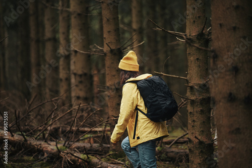 Woman hiking through a dense forest photo