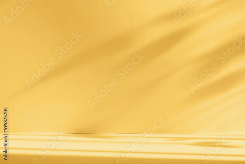 Abstract yellow color gradient studio background for product presentation. Empty room with shadows of window and flowers and palm leaves . 3d room with copy space. Summer concert. Blurred backdrop.