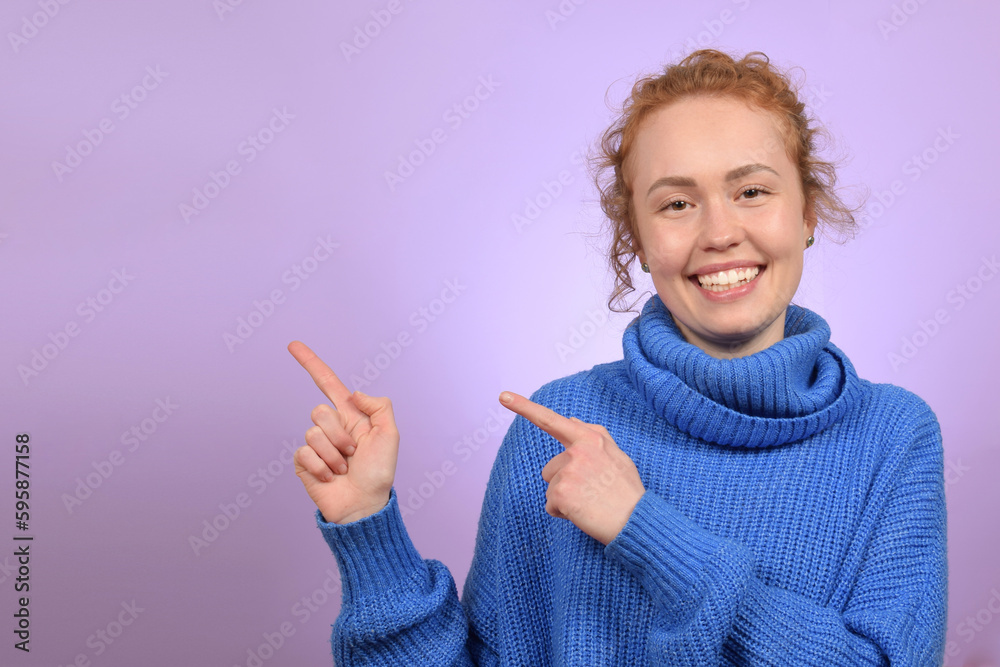 cute redhead curly young woman showing direction with fingers cute redhead curly young woman showing direction with fingers