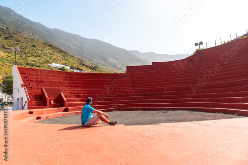 A tourist visiting the amphitheater next to the Nuestra Señora de Candelaria church in La Frontera on El Hierro, Canary Islands photo