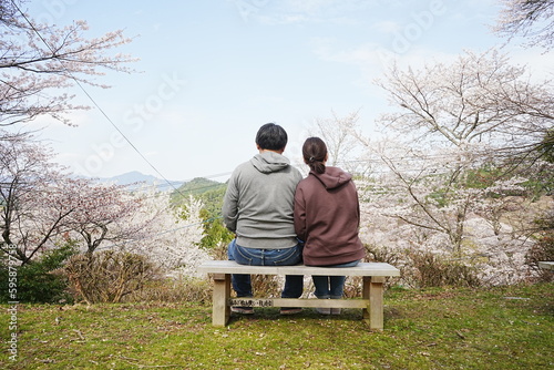 Couple  snuggle over Pink Sakura or Cherry Blossoms Flower Background. Yoshino-yama or Mount Yoshino in Nara, Japan. Image of Spring Season  - 日本 奈良 吉野山 桜 寄りそうカップル © Eric Akashi
