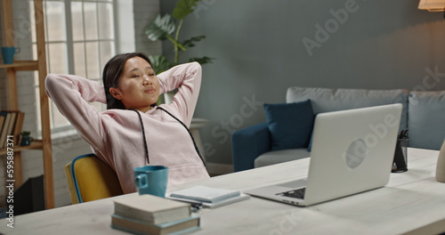 Copy space. Young successful female freelancer leaning back in her chair and relaxing with her eyes closed after finishing a project while remotely working at home 