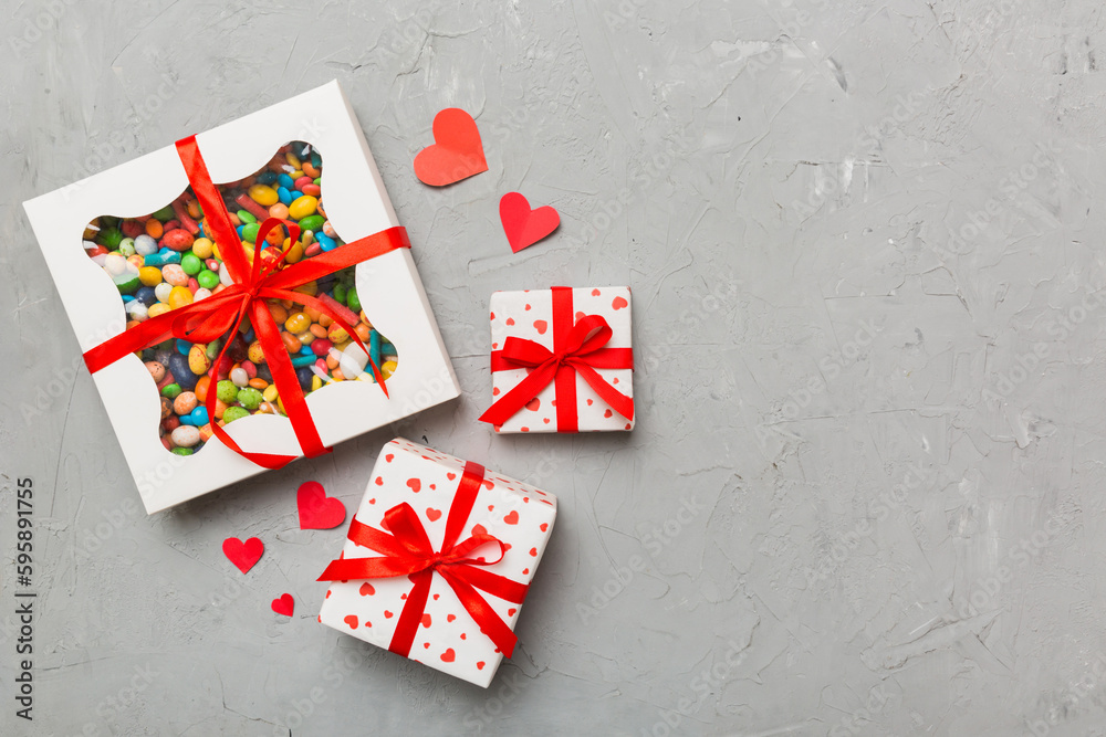 Valentine day composition: sweet candy, with gift boxes with bow and red felt hearts, photo template, background. Top View with copy space Valentine day composition: sweet candy, with gift boxes with bow and red felt hearts, photo template, background. Top View with copy space
