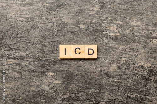 icd word written on wood block. international classification diseases text on table, concept photo