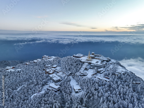 Aerial photography of snow covered Mount Emei in winter, the golden summit of Mount Emei in Sichuan(Huazang Temple), a famous Buddhist mountain in China photo