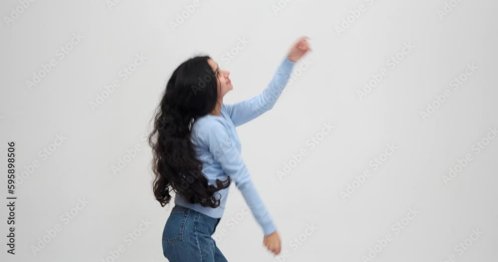 Young woman having fun dancing over white background Young woman having fun dancing over white background