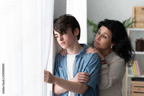 Mother comforting sad teenager son