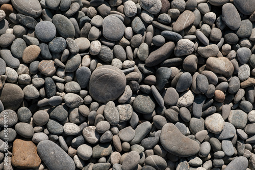 Grey pebbles on the beach near the sea baackground texture style