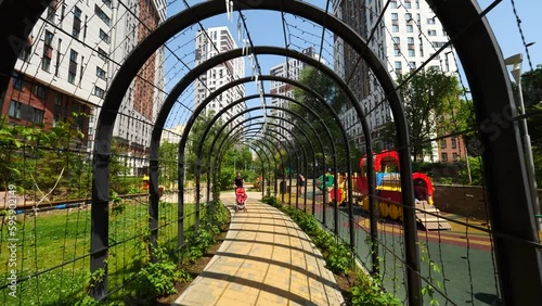we walk through the arch in the courtyard of a multi-storey residential building
