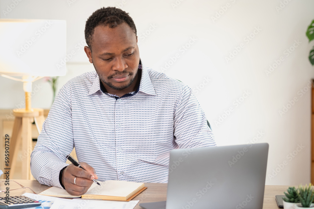 African American businessman smiling relaxed and crossed arms after analysis and research at home office African American businessman smiling relaxed and crossed arms after analysis and research at home office