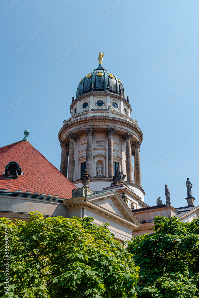View over the Gendarmenmarkt in Berlin with German Cathedral in historical and business downtown, Berlin, Germany, at summer sunny day and blue sky.