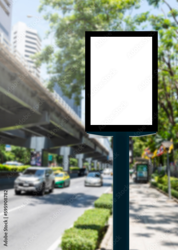 Fototapeta premium Outdoor pole vertical light box billboard with mock up white screen on footpath and clipping path