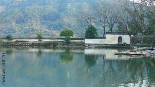 The beautiful traditional Chinese village view with the classical architecture and fresh green trees as background