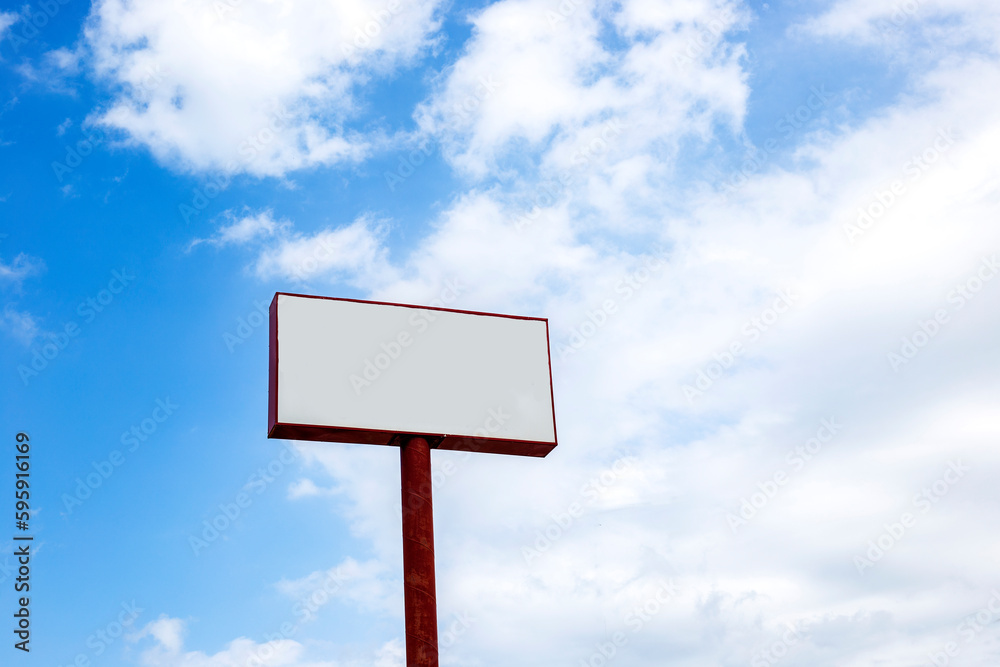Blank billboard on blue sky with white clouds for advertisement or copy space.