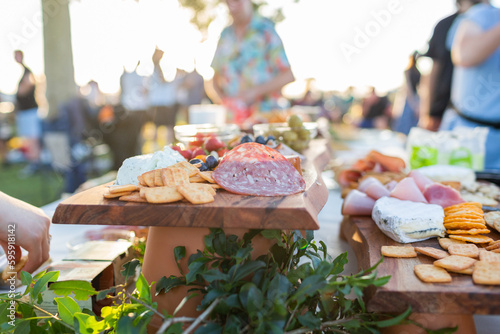 Flat meats and biscuits on grazing table at outdoor party event photo