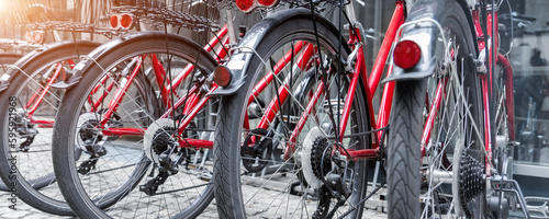 Fotografie, Tablou Closeup view many red city bikes parked in row at european city street rental parking sharing station or sale
