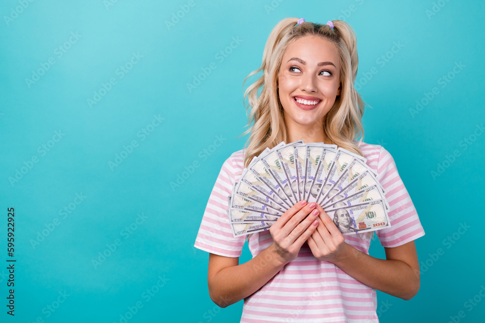 Photo of positive lovely lady wear striped stylish clothes look empty space interesting offer shopping isolated on cyan color background Photo of positive lovely lady wear striped stylish clothes look empty space interesting offer shopping isolated on cyan color background