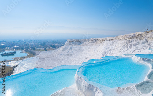 Thermal springs, natural baths Pamukkale, banner landmark of Turkey. Aerial top view blue water in travertine pool photo