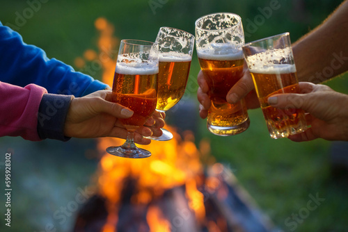 Family of different ages people cheerfully celebrate outdoors with glasses of beer proclaim toast