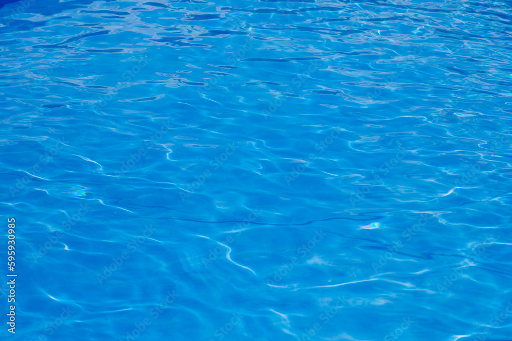 Clear blue water with glare from the sun in the pool