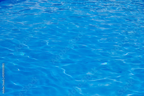 Clear blue water with glare from the sun in the pool