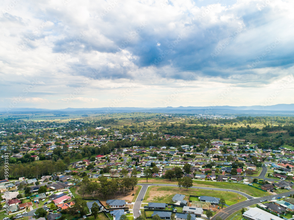 rays of light in clouded sky over Singleton Heights with new blocks of