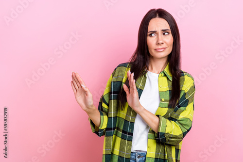Photo of unsatisfied person look arms palms show stop gesture empty space isolated on pink color background