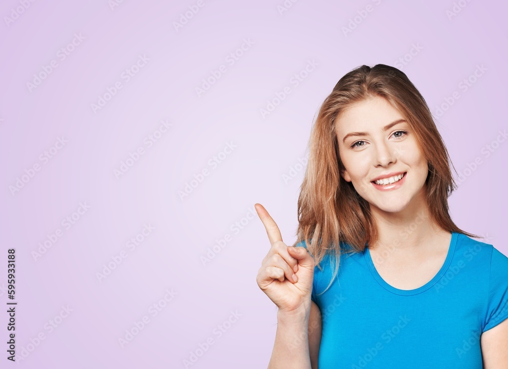 Happy young woman point to the side Happy young woman point to the side