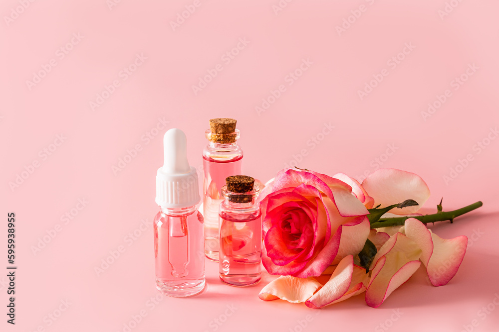 A set of cosmetics based on rose oil for face and body skin care. natural cosmetics. Pink background. A copy of the space. A set of cosmetics based on rose oil for face and body skin care. natural cosmetics. Pink background. A copy of the space.