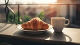 Balcony View of a Cup of Coffee and a French Croissant on a Table