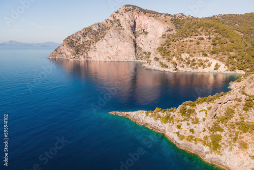 Fototapeta Naklejka Na Ścianę i Meble -  Winding coastline of Aegean seacoast with calm turquoise water in sunny day. Aerial view