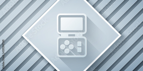 Paper cut Portable tetris electronic game icon isolated on grey background. Vintage style pocket brick game. Interactive playing device. Paper art style. Vector