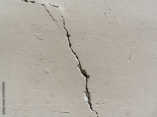 Brick wall texture with white shabby stucco, plaster. Red and white brickwall background, white stonewall surface. Plastered wall with white uneven stucco with cracks and damages