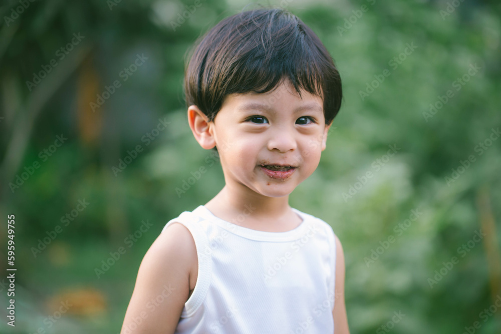 Asia boy he mouth aftertaste from eating chocolate ice cream or chocolate dessert. A Asia boy he mouth aftertaste from eating chocolate ice cream or chocolate dessert. A