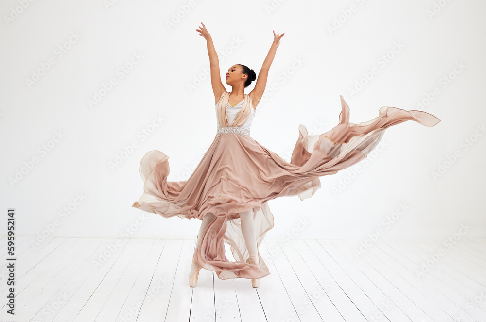 Nothing but dance. Full length shot of an attractive young female ballerina practicing in her dance studio. Nothing but dance. Full length shot of an attractive young female ballerina practicing in her dance studio.