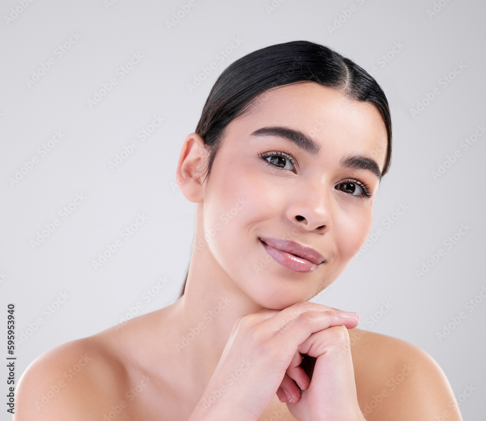 Simply beautiful. Studio portrait of an attractive young woman posing against a grey background. Simply beautiful. Studio portrait of an attractive young woman posing against a grey background.