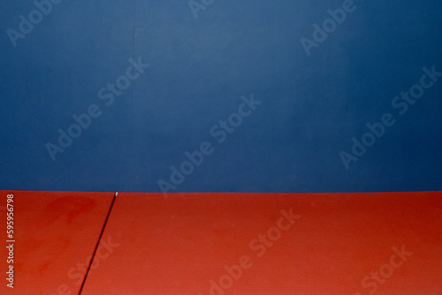 red judo mat on blue background