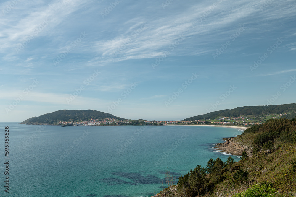 View of the fishing village of Fisterra and the cape of Finisterre View of the fishing village of Fisterra and the cape of Finisterre
