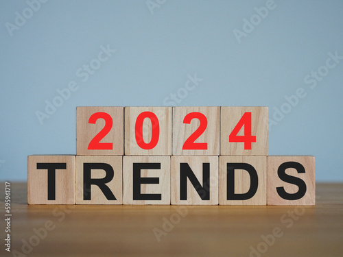 On a wooden cube with a trends 2024, the beginning of the new year. Trends of change, investment, starting a new business © MarutStudio