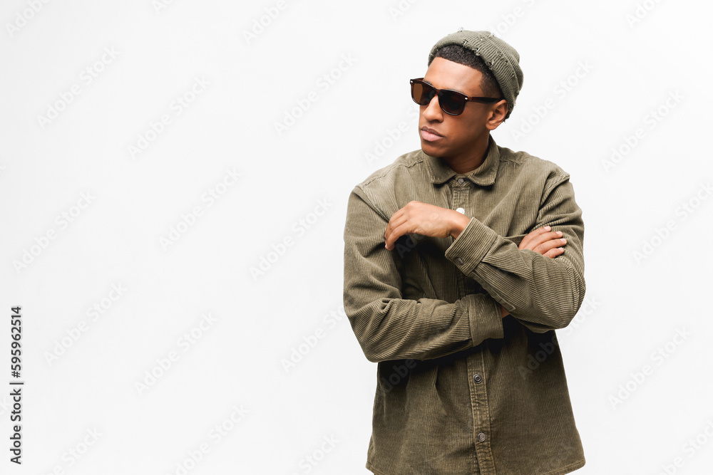 Handsome young african-american hipster man isolated on white, guy in sunglasses and hat looking away with serious face expression, fashion man posing Handsome young african-american hipster man isolated on white, guy in sunglasses and hat looking away with serious face expression, fashion man posing