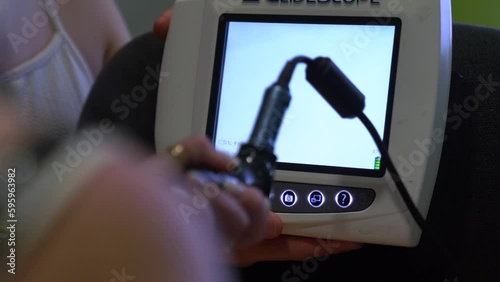 Respiratory Rescue Medical Practice. An anesthesiologist inserts a video laryngoscope into the mouth and throat of a male mannequin