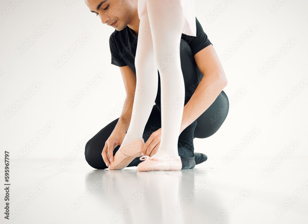 Position your feet like this. Closeup shot of a ballet teacher assisting a student with her position in a dance studio. Position your feet like this. Closeup shot of a ballet teacher assisting a student with her position in a dance studio.