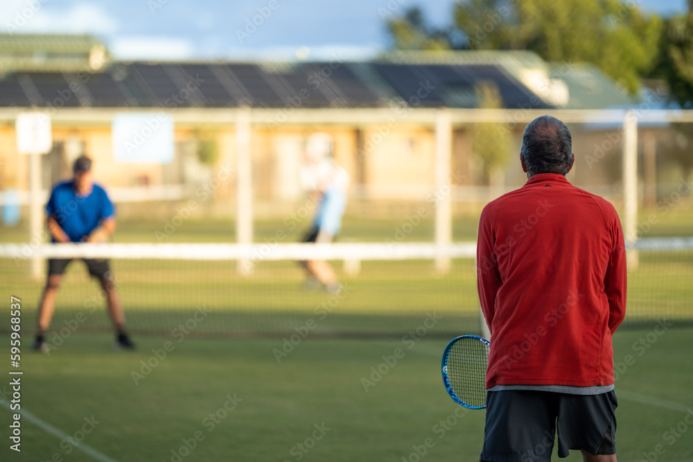 Amateur Tennis player, playing tennis at a tournament and match on grass in Europe