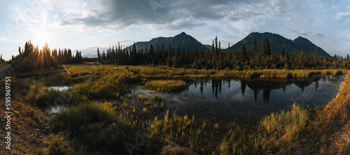 McCarthy Road view, McCarthy valley, Wrangell St. Elias National Park, Alaska. Meadow and mountains with a lake during sunset. Tundra landscape. photo