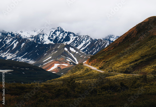 Alaska Denali National Park. Denali park road leading to colorful mountains. Spring and winter. Usa