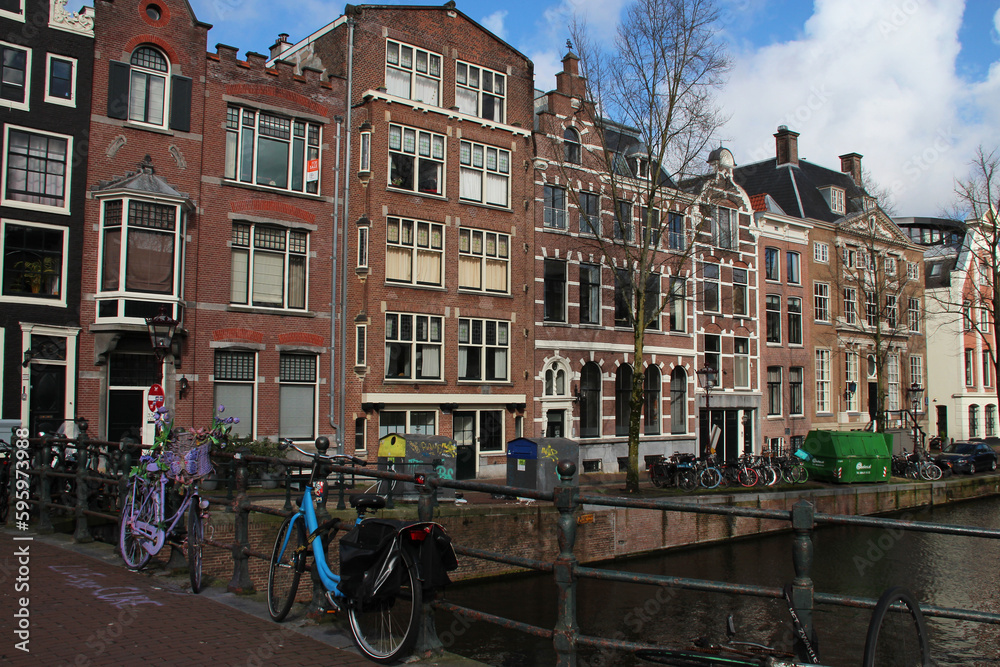 canal, river and old brick houses in amsterdam (the netherlands) 