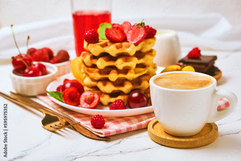 Breakfast table with stack of waffles and fresh berries Breakfast table with stack of waffles and fresh berries